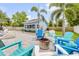 Inviting backyard firepit area with Adirondack chairs and landscaping at 90 Cunningham Dr, New Smyrna Beach, FL 32168
