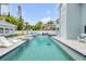 Gorgeous backyard featuring a long pool, lounge chairs and fire bowls at 90 Cunningham Dr, New Smyrna Beach, FL 32168