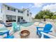 Large backyard with firepit area, pool, slide and plenty of seating at 90 Cunningham Dr, New Smyrna Beach, FL 32168