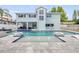 Stunning backyard with pool, spa, sun shelf, and outdoor seating at 90 Cunningham Dr, New Smyrna Beach, FL 32168