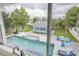 Backyard view featuring a large pool, adjacent spa, and detached building at 90 Cunningham Dr, New Smyrna Beach, FL 32168