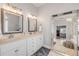 Elegant bathroom with double vanity, large mirror, and bright lighting, perfect for relaxation at 90 Cunningham Dr, New Smyrna Beach, FL 32168