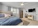 Well-lit bedroom features wood floors, two bright windows, and direct access to a private bathroom at 90 Cunningham Dr, New Smyrna Beach, FL 32168
