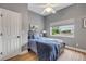 Comfortable bedroom features a bed with a wood headboard, a window, and a soothing gray color scheme at 90 Cunningham Dr, New Smyrna Beach, FL 32168