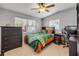 Bright bedroom with ceiling fan, hardwood floors, and view of the window, great for relaxing at 90 Cunningham Dr, New Smyrna Beach, FL 32168