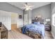 Bedroom with a bed, wood headboard, and an adjacent room showing an open doorway and a closet at 90 Cunningham Dr, New Smyrna Beach, FL 32168