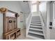 Entryway featuring coat rack, mirror, and stairs to the second level at 90 Cunningham Dr, New Smyrna Beach, FL 32168