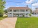 Stunning two-story home boasts dual balconies, a well-manicured lawn, and a charming facade at 90 Cunningham Dr, New Smyrna Beach, FL 32168