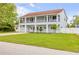 Stunning two-story home boasting dual balconies, a well-manicured lawn, and a charming facade at 90 Cunningham Dr, New Smyrna Beach, FL 32168