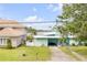 Charming home with a well-kept lawn and lush landscaping at 90 Cunningham Dr, New Smyrna Beach, FL 32168