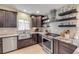 Well-appointed kitchen with stainless steel appliances, sleek cabinetry, and granite countertops at 90 Cunningham Dr, New Smyrna Beach, FL 32168