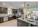 Gourmet kitchen featuring granite countertops, stainless appliances, custom cabinetry, and pendant lighting at 90 Cunningham Dr, New Smyrna Beach, FL 32168