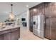 Open kitchen with stainless appliances, granite counters, and direct sight lines to the adjacent living spaces at 90 Cunningham Dr, New Smyrna Beach, FL 32168