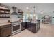 Open layout kitchen with granite counters, stainless appliances, and designer accents at 90 Cunningham Dr, New Smyrna Beach, FL 32168