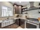 Close up shot of a well-equipped kitchen with stainless steel appliances, granite countertops, and designer backsplash at 90 Cunningham Dr, New Smyrna Beach, FL 32168