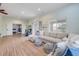 Bright living room with wood floors, recessed lights, and sliding door access to the outdoors at 90 Cunningham Dr, New Smyrna Beach, FL 32168