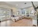 Bright living room with hardwood floors, a large sectional sofa, and natural light at 90 Cunningham Dr, New Smyrna Beach, FL 32168