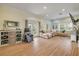 Spacious living room with hardwood floors, a large sectional sofa, and ample natural light at 90 Cunningham Dr, New Smyrna Beach, FL 32168