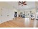 Open concept living room with wood floors, recessed lights, and views to an outdoor area at 90 Cunningham Dr, New Smyrna Beach, FL 32168