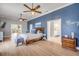 Inviting primary bedroom featuring a blue accent wall, ensuite bath access and plenty of space at 90 Cunningham Dr, New Smyrna Beach, FL 32168