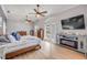 Bright and airy primary bedroom with ceiling fans and large windows for a serene atmosphere at 90 Cunningham Dr, New Smyrna Beach, FL 32168