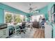 Bright home office featuring custom shelving, large window, and wood-look vinyl floors at 90 Cunningham Dr, New Smyrna Beach, FL 32168