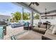 Covered patio features outdoor seating with a view of the pool and backyard oasis at 90 Cunningham Dr, New Smyrna Beach, FL 32168