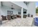 Covered patio with outdoor seating, dining and entertainment at 90 Cunningham Dr, New Smyrna Beach, FL 32168
