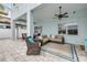 Covered patio with sectional seating and overhead ceiling fan at 90 Cunningham Dr, New Smyrna Beach, FL 32168