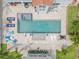 Aerial view of a backyard pool and spa with pavers, lounge chairs, and a detached guest house at 90 Cunningham Dr, New Smyrna Beach, FL 32168