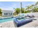 Backyard featuring a pool, adjacent spa, and outdoor seating area at 90 Cunningham Dr, New Smyrna Beach, FL 32168