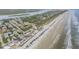 Breathtaking aerial view of the beach house nestled in its coastal setting at 951 N Atlantic Ave, New Smyrna Beach, FL 32169