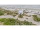 Stunning aerial view of modern beachfront house on sandy beach at 951 N Atlantic Ave, New Smyrna Beach, FL 32169