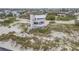 Aerial view of a unique coastal home with balconies, nestled on the beach, showcasing ocean views at 951 N Atlantic Ave, New Smyrna Beach, FL 32169