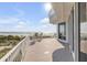 Balcony with chairs, a small table and sweeping views of the ocean and beach at 951 N Atlantic Ave, New Smyrna Beach, FL 32169