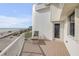 Relax on this balcony with ocean views, a comfortable lounge chair and access to the door and window at 951 N Atlantic Ave, New Smyrna Beach, FL 32169