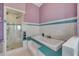Bright bathroom featuring a soaking tub with blue accent tiles and a glass-enclosed shower at 951 N Atlantic Ave, New Smyrna Beach, FL 32169
