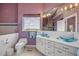 Bright bathroom with double sinks, modern fixtures, a large mirror, and ample counter space at 951 N Atlantic Ave, New Smyrna Beach, FL 32169