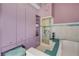 Spacious bathroom featuring a glass-enclosed shower, soaking tub, and ample storage at 951 N Atlantic Ave, New Smyrna Beach, FL 32169