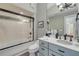Bathroom with a tub-shower, blue vanity, sink and cabinets at 951 N Atlantic Ave, New Smyrna Beach, FL 32169