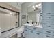 Bathroom with a tub-shower, blue vanity, sink and cabinets at 951 N Atlantic Ave, New Smyrna Beach, FL 32169