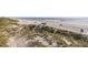 Expansive beach vista with sand dunes, beach vehicles and lifeguard stand at 951 N Atlantic Ave, New Smyrna Beach, FL 32169