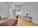 Bedroom with glass side table, light wood floors and gray chaise lounge at 951 N Atlantic Ave, New Smyrna Beach, FL 32169