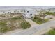 Aerial view of the beachfront home with lush landscaping, a driveway, and panoramic ocean views at 951 N Atlantic Ave, New Smyrna Beach, FL 32169