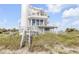 Charming two-story coastal home with private balconies, and access to the beach at 951 N Atlantic Ave, New Smyrna Beach, FL 32169