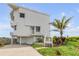 Beautiful beachfront house featuring a well-manicured lawn and a private driveway at 951 N Atlantic Ave, New Smyrna Beach, FL 32169