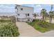 Beachfront home with a private driveway and lush, tropical landscaping at 951 N Atlantic Ave, New Smyrna Beach, FL 32169