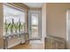 Hallway with glass table, plants, and door that lead to an outdoor balcony overlooking the ocean at 951 N Atlantic Ave, New Smyrna Beach, FL 32169