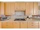 Close up of range on stone countertop in kitchen with custom cabinets at 951 N Atlantic Ave, New Smyrna Beach, FL 32169