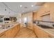 Open kitchen with custom cabinets, stone countertops, modern appliances, and open view of living area at 951 N Atlantic Ave, New Smyrna Beach, FL 32169